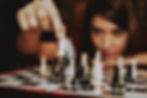 A girl playing chess with herself.