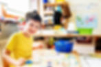 Thumbnail: Child painting in an art studio