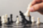 Thumbnail: A human hand moving a piece on the chess board