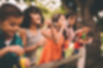 5 children standing beside each other and blowing soap bubbles