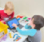 Two kids working on Lego Robotics Spike Essential kit.