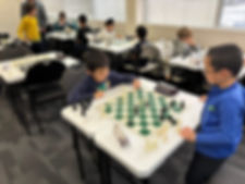 Children playing chess during a chess tournament at Flying Minds education centre chess club