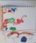 Colorful drawing of animals and objects on a white spiral notebook page; includes a tree, bird, lizard, pink insect, and various symbols.