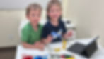 Two boys working on Lego Spike model during a school break camp