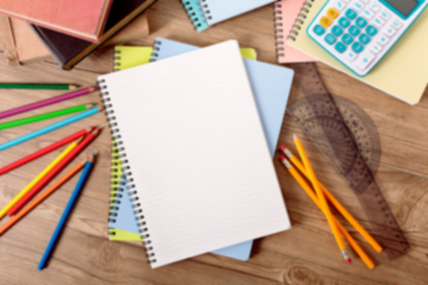 notebook, pencils and geometry tools on the desk